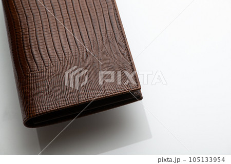Close-up shot of a fashionable leather men's wallet on a white background with reflection 105133954