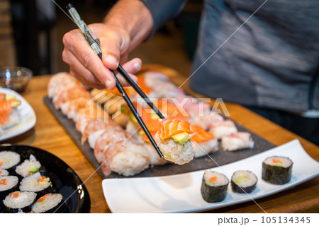 Overhead japanese sushi food. Maki ands rolls with tuna, salmon, shrimp, crab and avocado. Top view of assorted sushi. 105134345