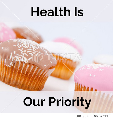 Composition of health is our priority text over cupcakes Composition of health is our priority text over cupcakes 105137441