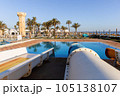 Empty small aquapark sliders with pool and palm trees at the morning, Tunisia 105138107
