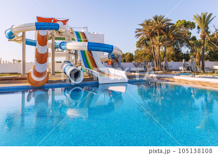 Empty small aquapark sliders with pool and palm trees at the morning, Tunisia 105138108