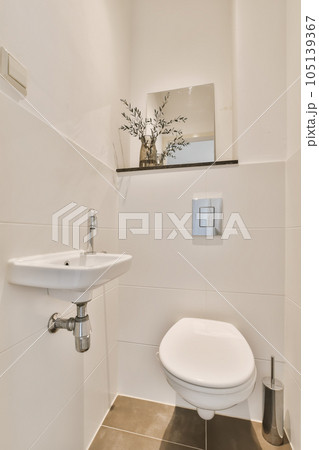 a bathroom with a sink and mirror on the wall above it is an image of a flower in a vase 105139367