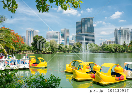 Lumpini Park green forest lake and buildings in Bangkok, Thailand Lumpini Park green forest lake and buildings in Bangkok, Thailand 105139917