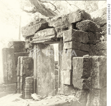 Snapshot showcasing the wreckage of an old building in Cambodia, epitomized by medieval stone remains. 105140142