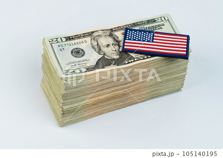 American flag on pile of 20 dollar banknote 105140195