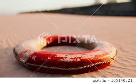 Lifebuoy on the city beach at sunset 105140321