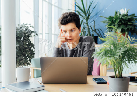 Middle aged shocked business woman sitting in front of laptop looking at screen at her workstation in office. Frustrated worried face expression emotion feelings problem perception reaction. 105140461
