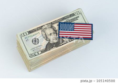 20 dollar bill stack of money with American flag on top isolated 20 dollar bill stack of money with American flag on top isolated 105140500
