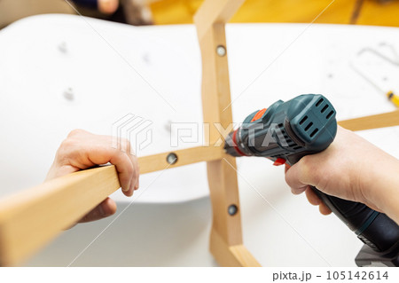 Craftsman collecting with tools, assembling furniture with screwdriver 105142614