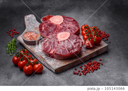 Fresh raw beef steak with bone or ossobuco with salt, spices and herbs Fresh raw beef steak with bone or ossobuco with salt, spices and herbs 105143066