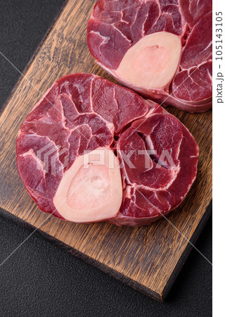 Fresh raw beef steak with bone or ossobuco with salt, spices and herbs 105143105