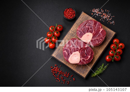 Fresh raw beef steak with bone or ossobuco with salt, spices and herbs 105143107