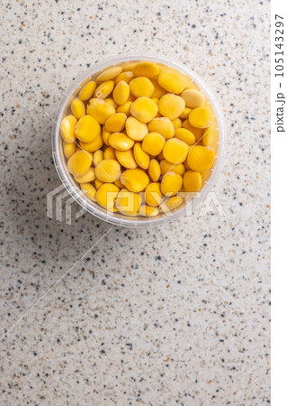Lupini beans in brine. Pickled lupin in bowl on kitchen table. Top view. Lupini beans in brine. Pickled lupin in bowl on kitchen table. Top view. 105143297