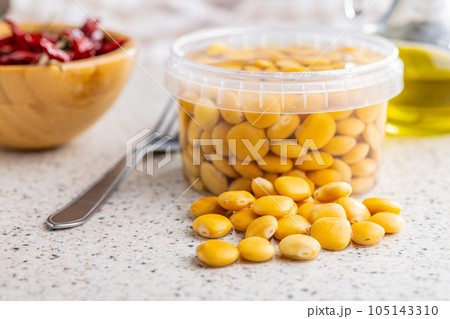 Lupini beans in brine. Pickled lupin in bowl on kitchen table. 105143310