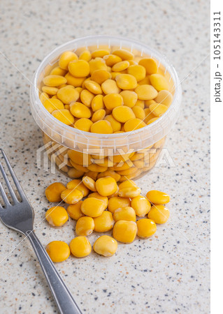 Lupini beans in brine. Pickled lupin in bowl on kitchen table. Lupini beans in brine. Pickled lupin in bowl on kitchen table. 105143311