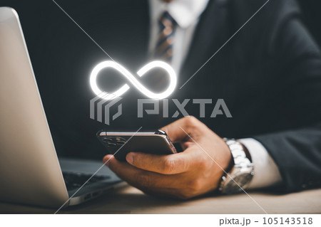 Businessman presents smartphone with infinity symbol, signifying limitless connection in data technology, future unlimited. Infinite power, energy, internet information. technology infinity data Businessman presents smartphone with infinity symbol, signifying limitless connection in data technology, future unlimited. Infinite power, energy, internet information. technology infinity data 105143518