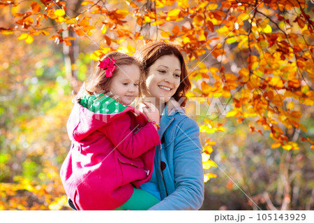 Mother and kid in autumn. Fall outdoor family fun. 105143929