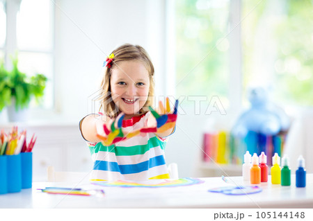 Kids paint. Child painting. Little girl drawing. 105144148
