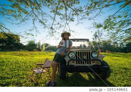 Asian adventure woman camping in tree froest with small truck car 105149601