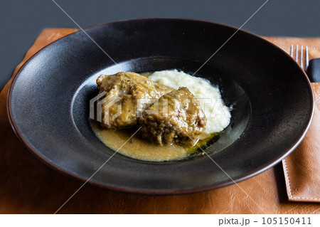 Simple serving portion of slow roasted pork steak with gravy, an Italian delicacy in Montepulciano Tuscany 105150411