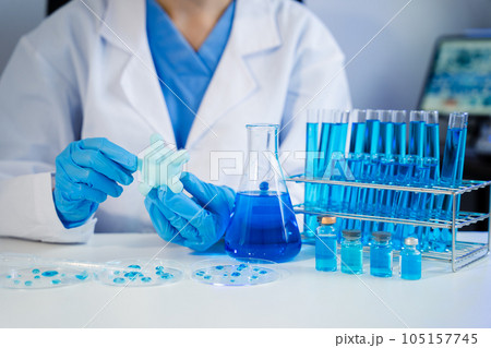 Medical test vaccine research and development concept. Scientist in laboratory study and analyze scientific sample of antibody. Medical test vaccine research and development concept. Scientist in laboratory study and analyze scientific sample of antibody. 105157745
