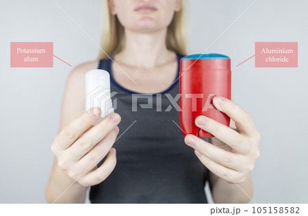 left or right. Girl chooses between eco-friendly deodorant without toxins and antiperspirant with toxic elements. In left hand Mineral alum crystal stick, in right hand classic remedy chemical nature 105158582