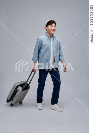 Full size photo of young man happy positive smile travel abroad isolated over white background Full size photo of young man happy positive smile travel abroad isolated over white background 105158683