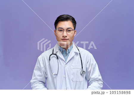 portrait of friendly Asian doctor man at his office smiling to camera portrait of friendly Asian doctor man at his office smiling to camera 105158698