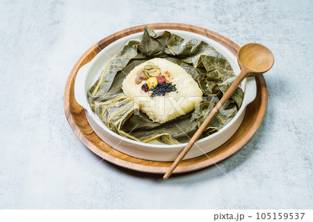 yeonnipbap, korean lotus leaf rice, Glutinous rice, dates, and chestnuts wrapped in a lotus leaf and steamed in a steamer. In the past, this dish was made and consumed by Buddhist monks, but it is now yeonnipbap, korean lotus leaf rice, Glutinous rice, dates, and chestnuts wrapped in a lotus leaf and steamed in a steamer. In the past, this dish was made and consumed by Buddhist monks, but it is now 105159537