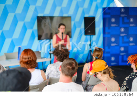 Woman speaking in front of audience on conference Woman speaking in front of audience on conference 105159564