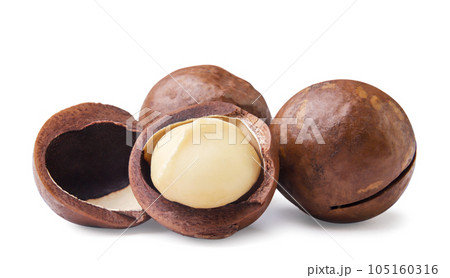 Macadamia nuts and broken close-up on a white background. Macadamia nuts and broken close-up on a white background. 105160316