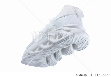 White sports sneakers with corrugated soles on a white background. 105160682