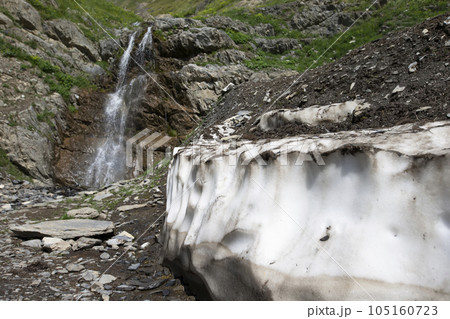 Waterfall in the mountains against the backdrop of a descended glacier. Waterfall in the mountains against the backdrop of a descended glacier. 105160723