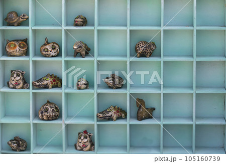 Handmade clay children's toys of fabulous animals lie in wooden cells. Handmade clay children's toys of fabulous animals lie in wooden cells. 105160739