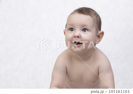 Six month old baby on a white background. Happy boy mid-range. Conceptual photo of fatherhood and motherhood.Alpha generation. 105161183