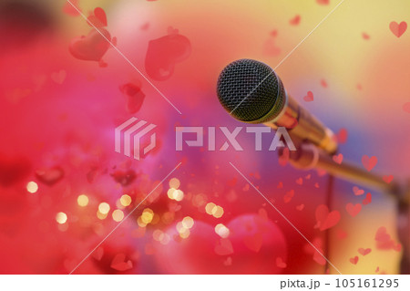 Stage golden microphone on the background of red valentine hearts and golden bokeh. Stage golden microphone on the background of red valentine hearts and golden bokeh. 105161295