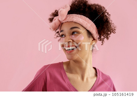 Smiling attractive mixed race girl with clean skin and pink patches under her eyes Smiling attractive mixed race girl with clean skin and pink patches under her eyes 105161419