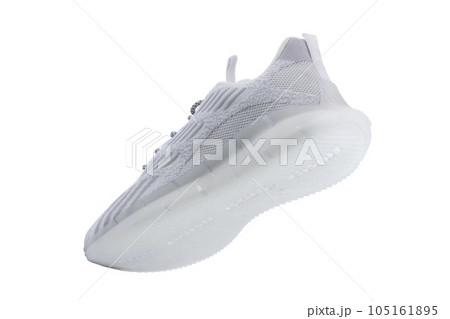 Sneaker one made of white fabric with lacing on a white background. Sneaker one made of white fabric with lacing on a white background. 105161895