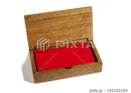 Open wooden box with a red purse on a white background. Gift box. 105162164