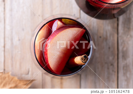 Autumn sangria with pear and apple on wooden table 105162478
