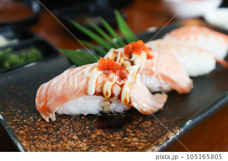 salmon sushi or rice topped with salmon and sushi or shrimp sushi or shrimp rolls, rice topped with shrimp or prawn rolls salmon sushi or rice topped with salmon and sushi or shrimp sushi or shrimp rolls, rice topped with shrimp or prawn rolls 105165805