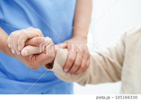 Doctor holding hands Asian elderly woman patient, help and care in hospital. Doctor holding hands Asian elderly woman patient, help and care in hospital. 105166330