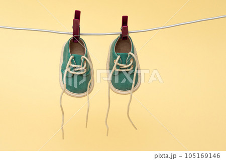 Baby shoes hanging on the clothesline. Newborn concept Baby shoes hanging on the clothesline. Newborn concept 105169146
