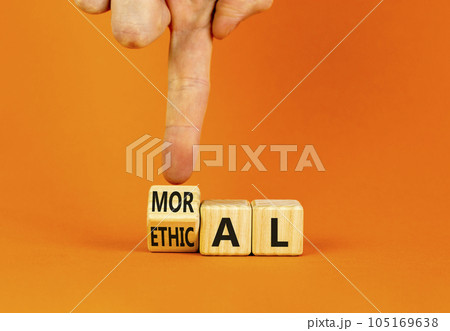 Ethical or moral symbol. Businessman turns wooden cubes and changes the word Ethical to Moral on a beautiful orange table orange background. Business and ethical or moral concept. Copy space. 105169638