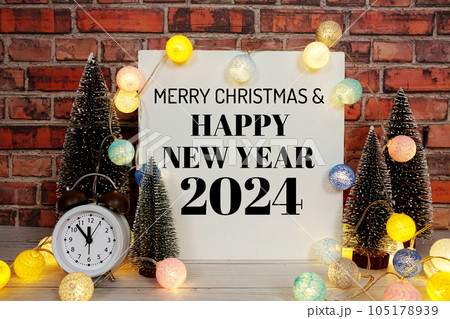 Happy New Year 2024 text message with alarm clock and LED cotton balls decoration Happy New Year 2024 text message with alarm clock and LED cotton balls decoration 105178939