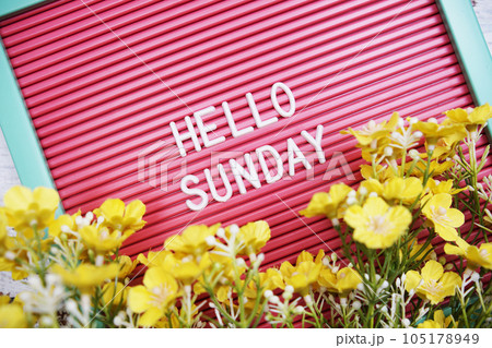 Hello Sunday text on Letter Board with flower decoration 105178949