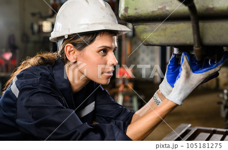 Confident female technician engineer worker checking and inspecting machine Confident female technician engineer worker checking and inspecting machine 105181275