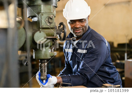 Portrait of happy male industrial worker in white hard hat working 105181399
