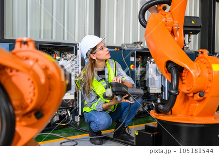 Female engineer worker working with robotic machine automation 105181544