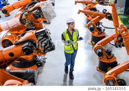 Female business owner engineer managing and checking work at factory Female business owner engineer managing and checking work at factory 105181555